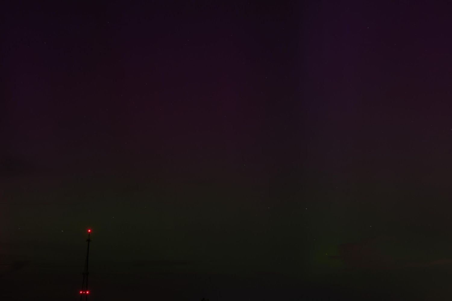 Blue, purple and green hues largely dominate behind a radio tower in Germantown, Ohio.