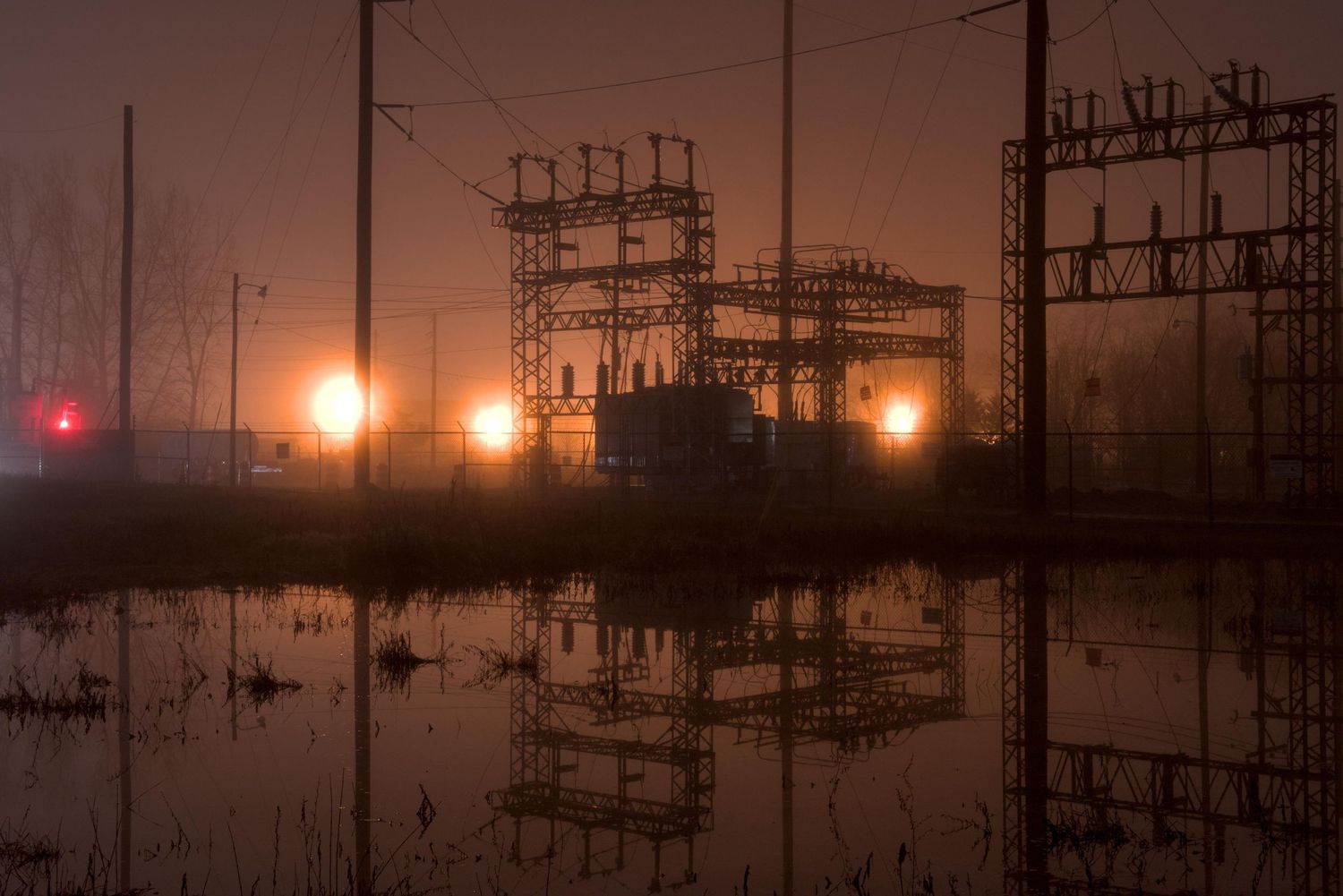 Amber lights illuminate the fog by an electrical substation in Lewisburg, Ohio.