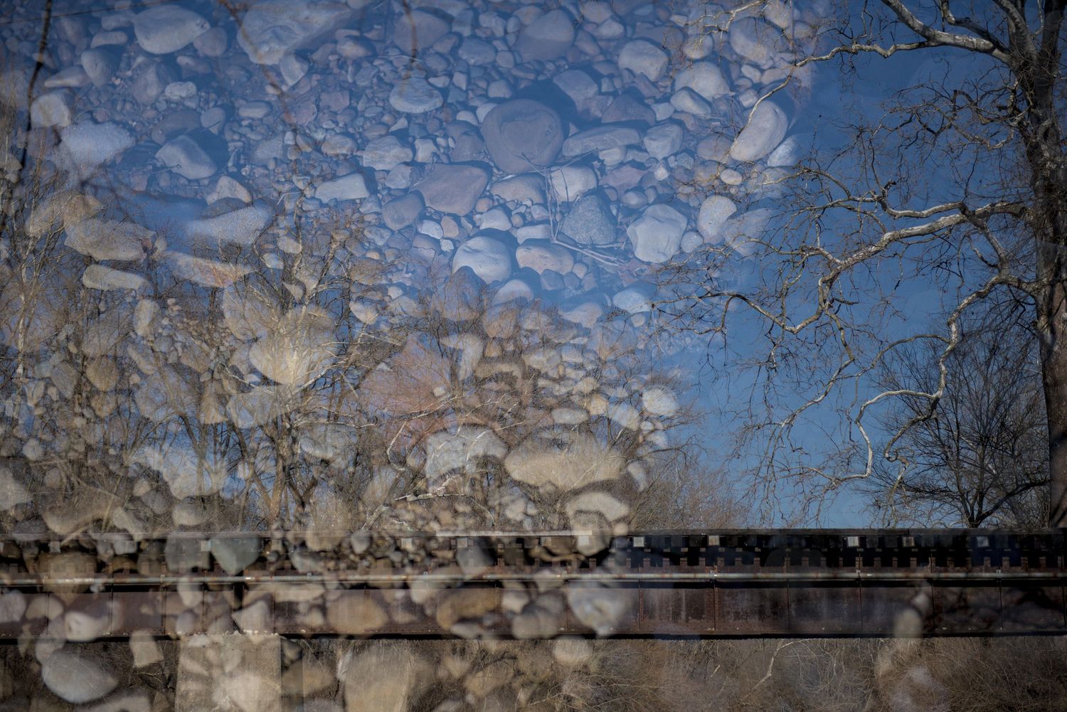 The gravel by Twin Creek is layered over an image of the railroad trestle.