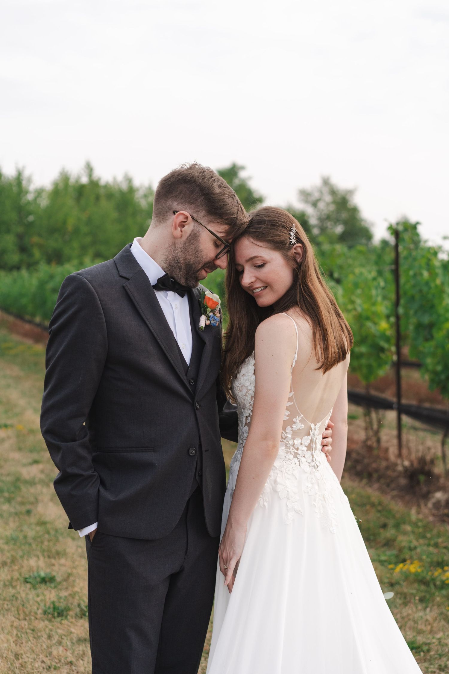 Bride and groom sharing a quiet, intimate moment among the vineyards at Calamus Estate Winery in Jordan, Ontario.
