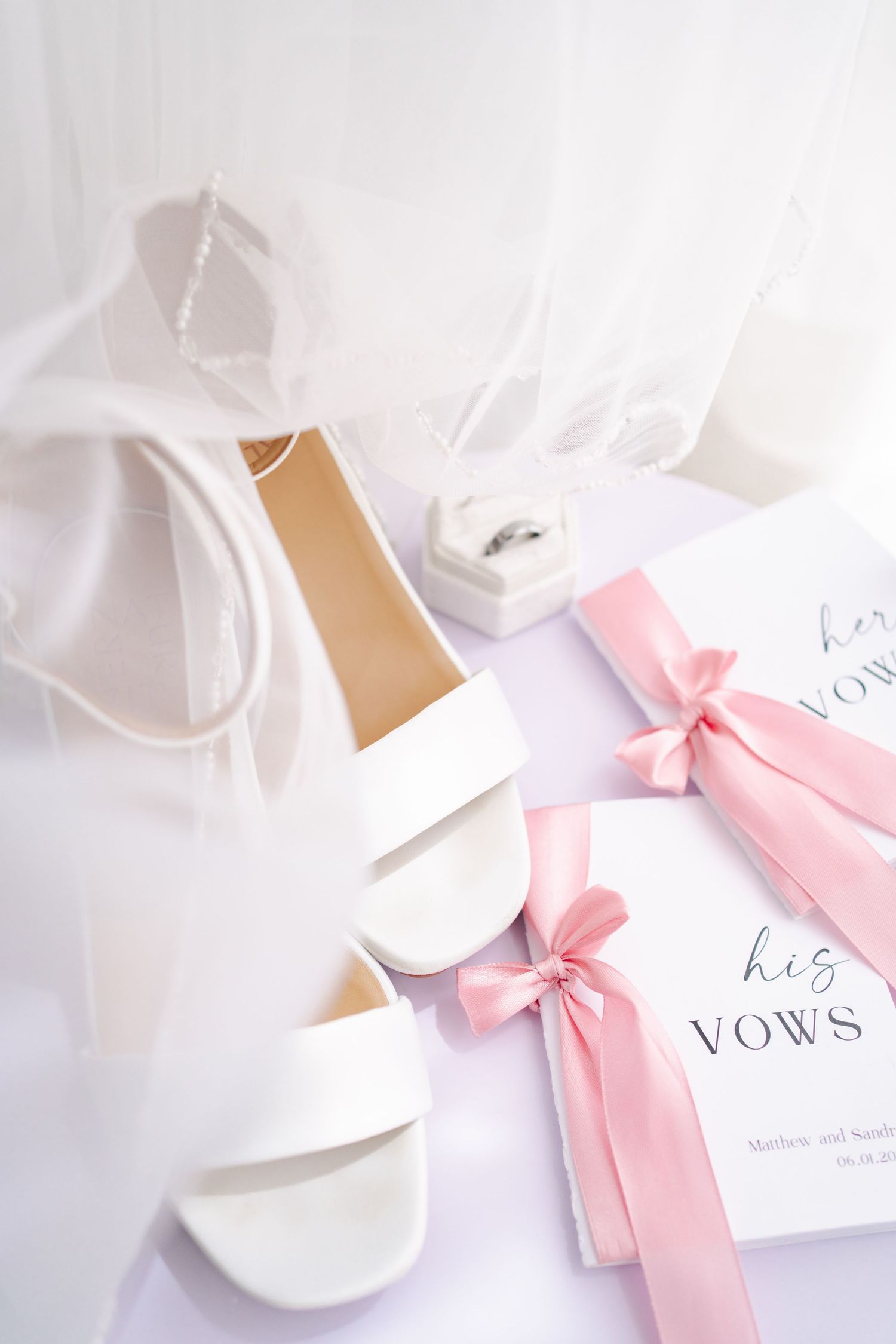White bridal shoes, champagne bottle, and wedding accessories arranged for bridal preparations at ESpace Studios.