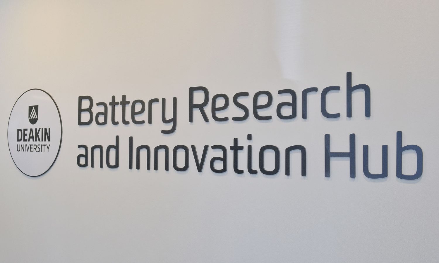Wall signage reading Deakin University Battery Research and Innovation Hub with the university logo.