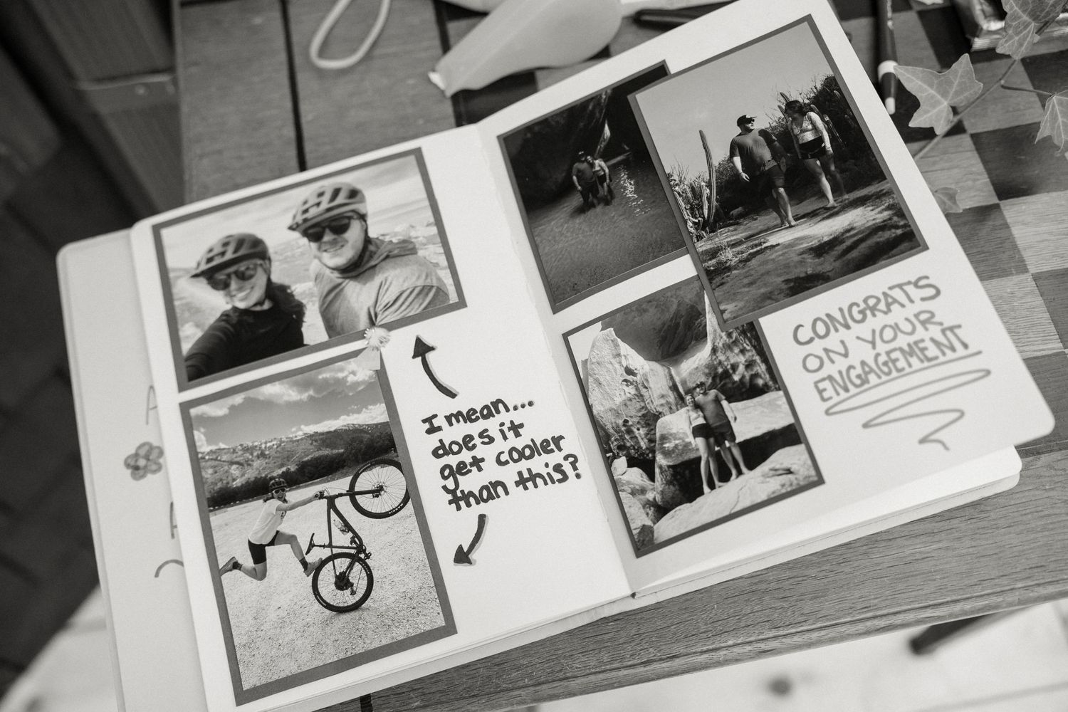 Black and white photo of a scrapbook with cycling photos and a congrats on your engagement note.