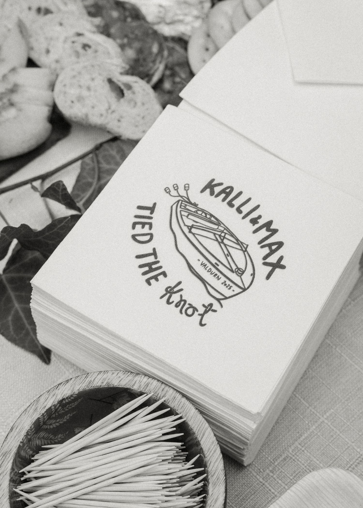 Elegant wedding napkins printed with Kalli and Max tied the knot design surrounded by decorative items.