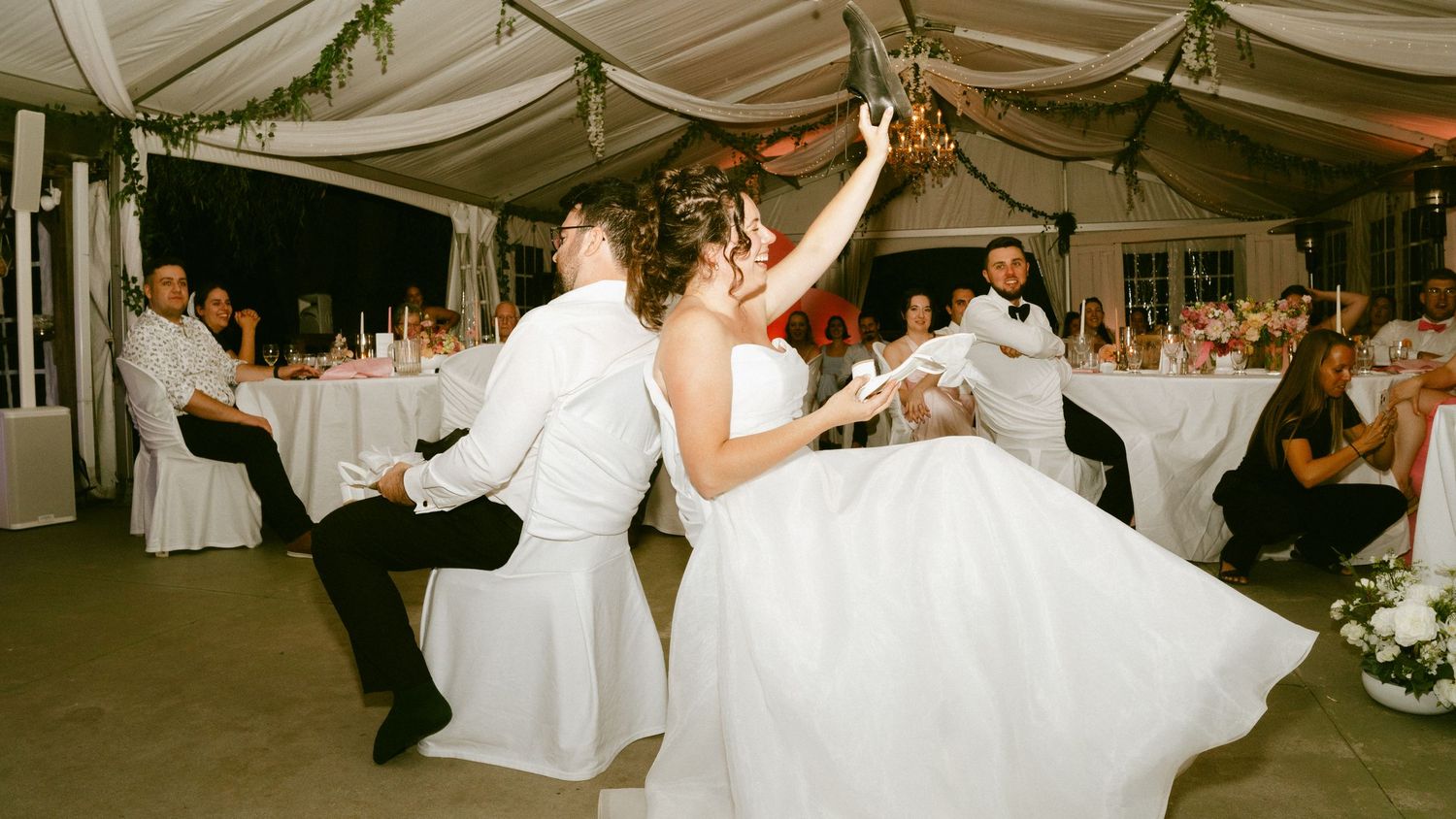 Bride and groom sharing a lively first dance at wedding reception.