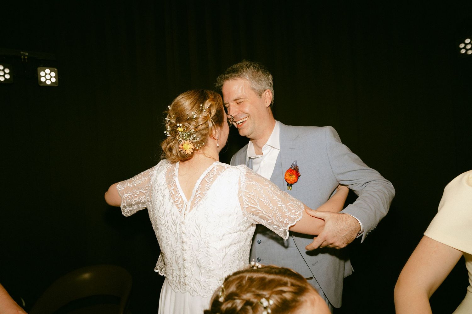 A bride and groom share a joyful dance at their wedding reception.