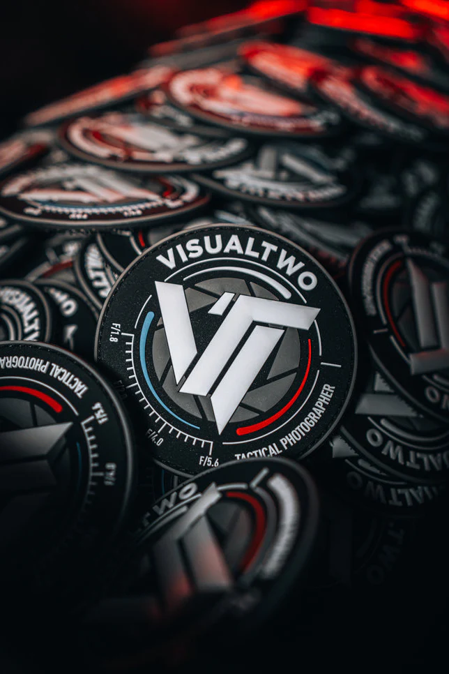 Black circular patches for VisualTwo Tactical Photographer with VT logo, red and blue accents, stacked together.