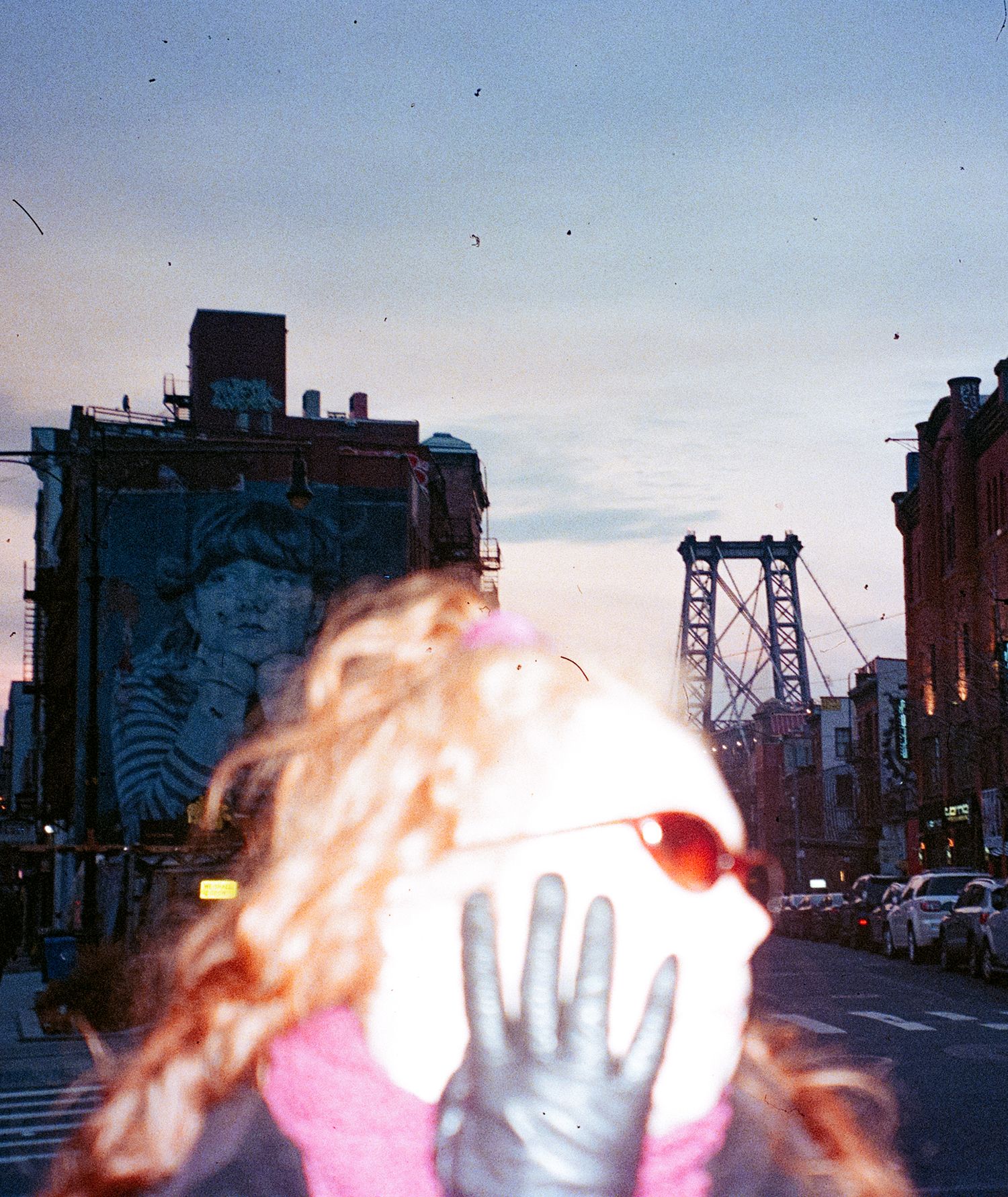 Blurred redhair on a city street at dusk.