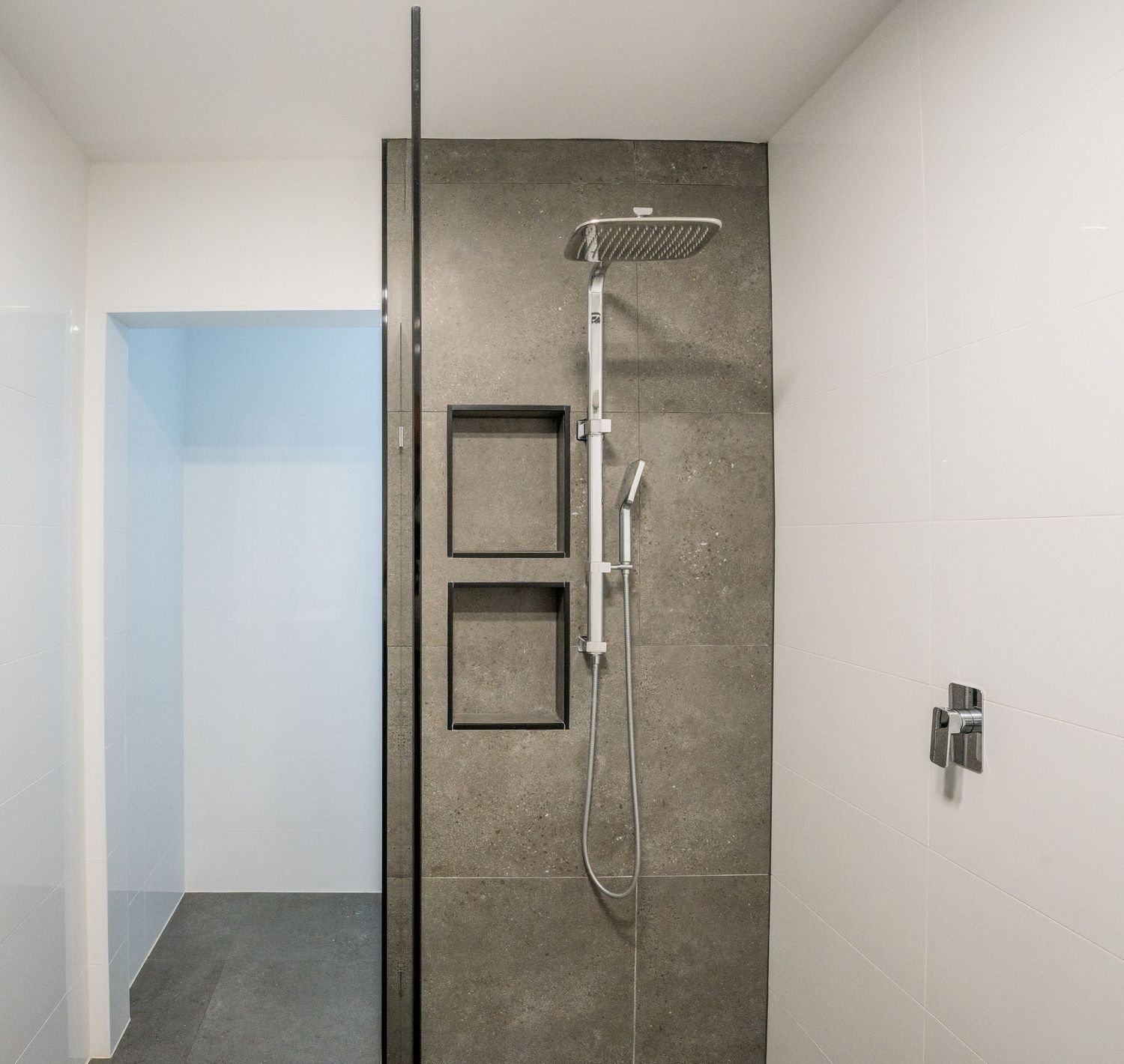 Bright modern bathroom with clean tiles and natural light.
