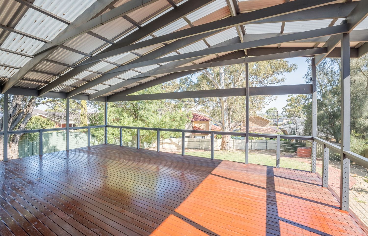 Outdoor deck area with seating and natural timber textures.