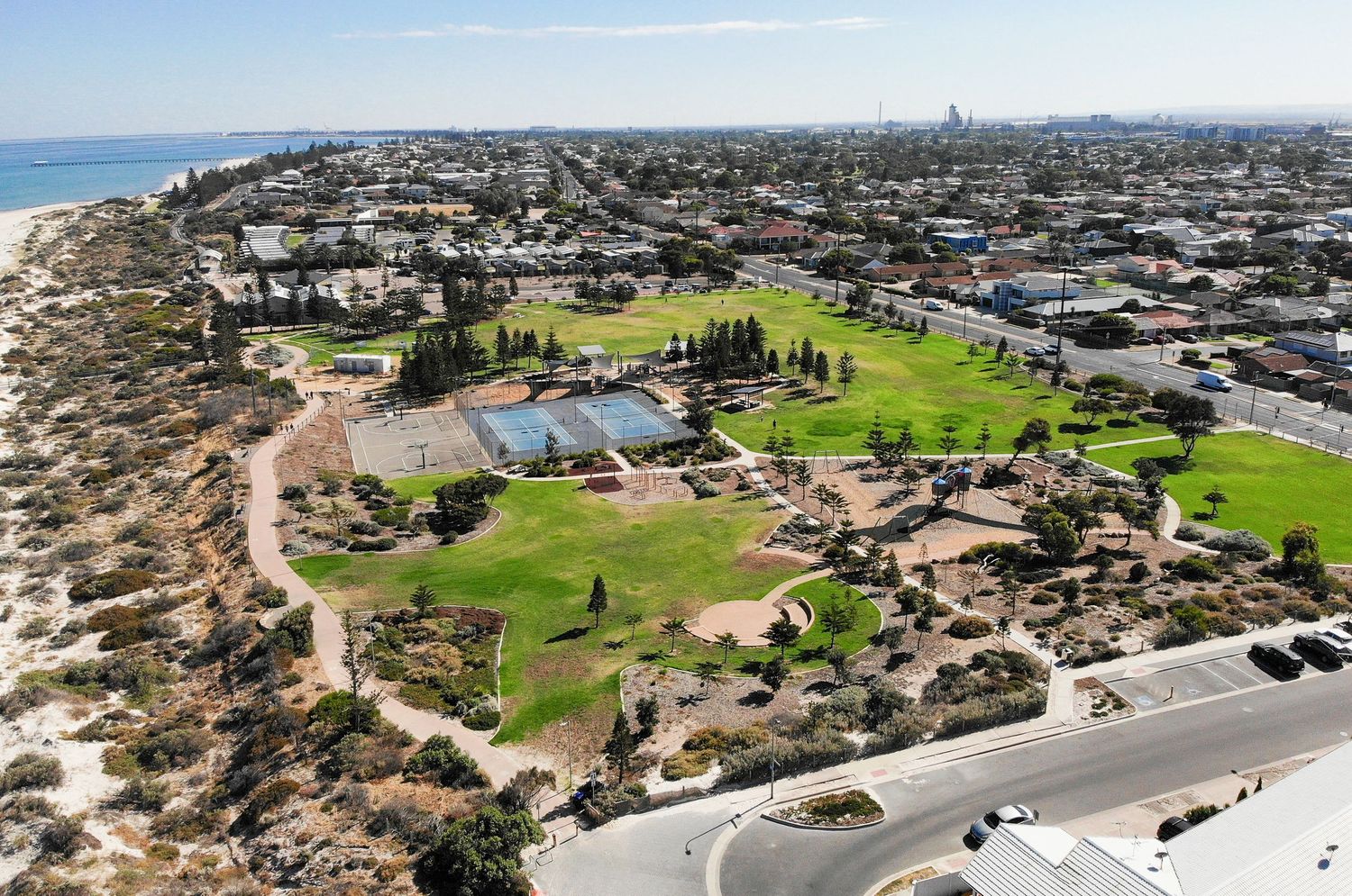 Birds‑eye drone view over parklands and natural scenery.