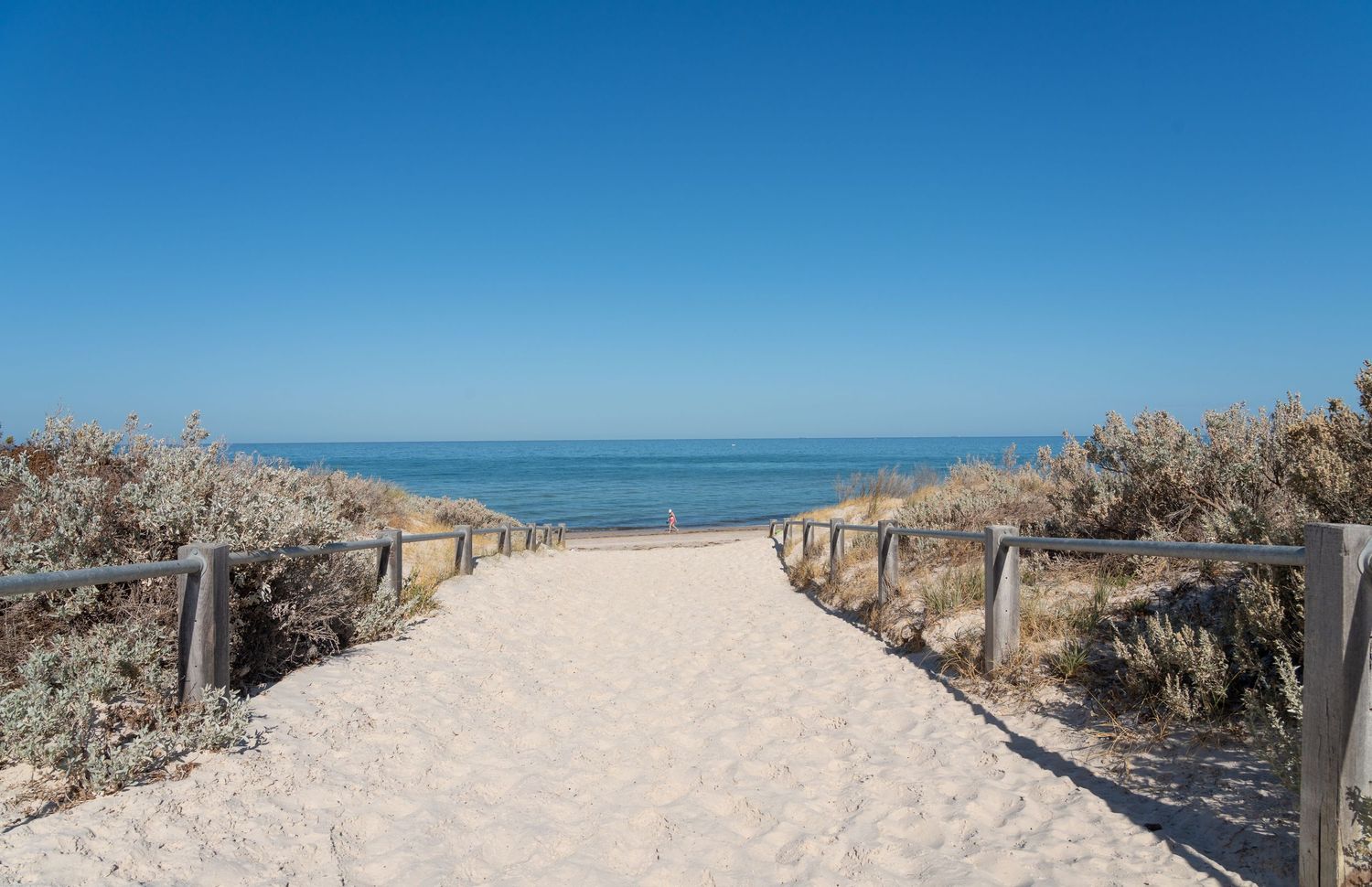 Coastal walking path leading towards the beach.