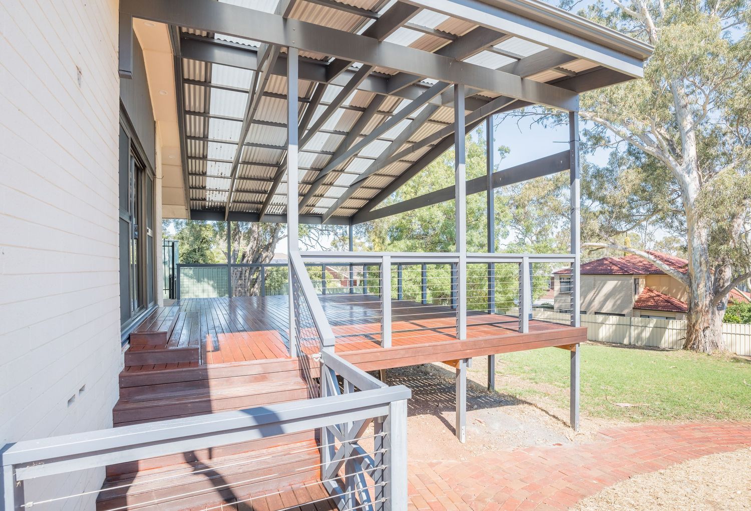 Outdoor deck area with seating and natural timber textures.