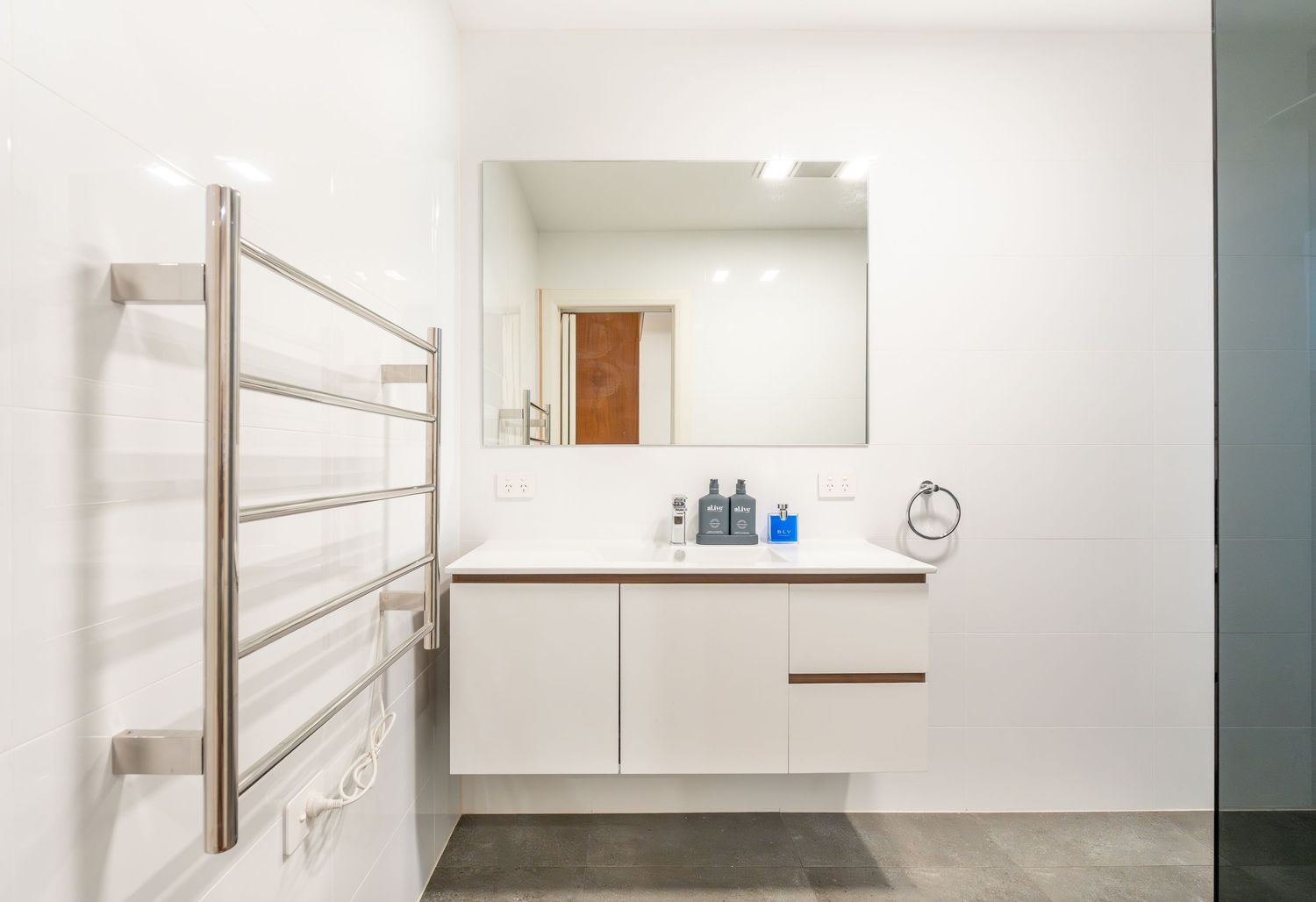Bright modern bathroom with clean tiles and natural light.