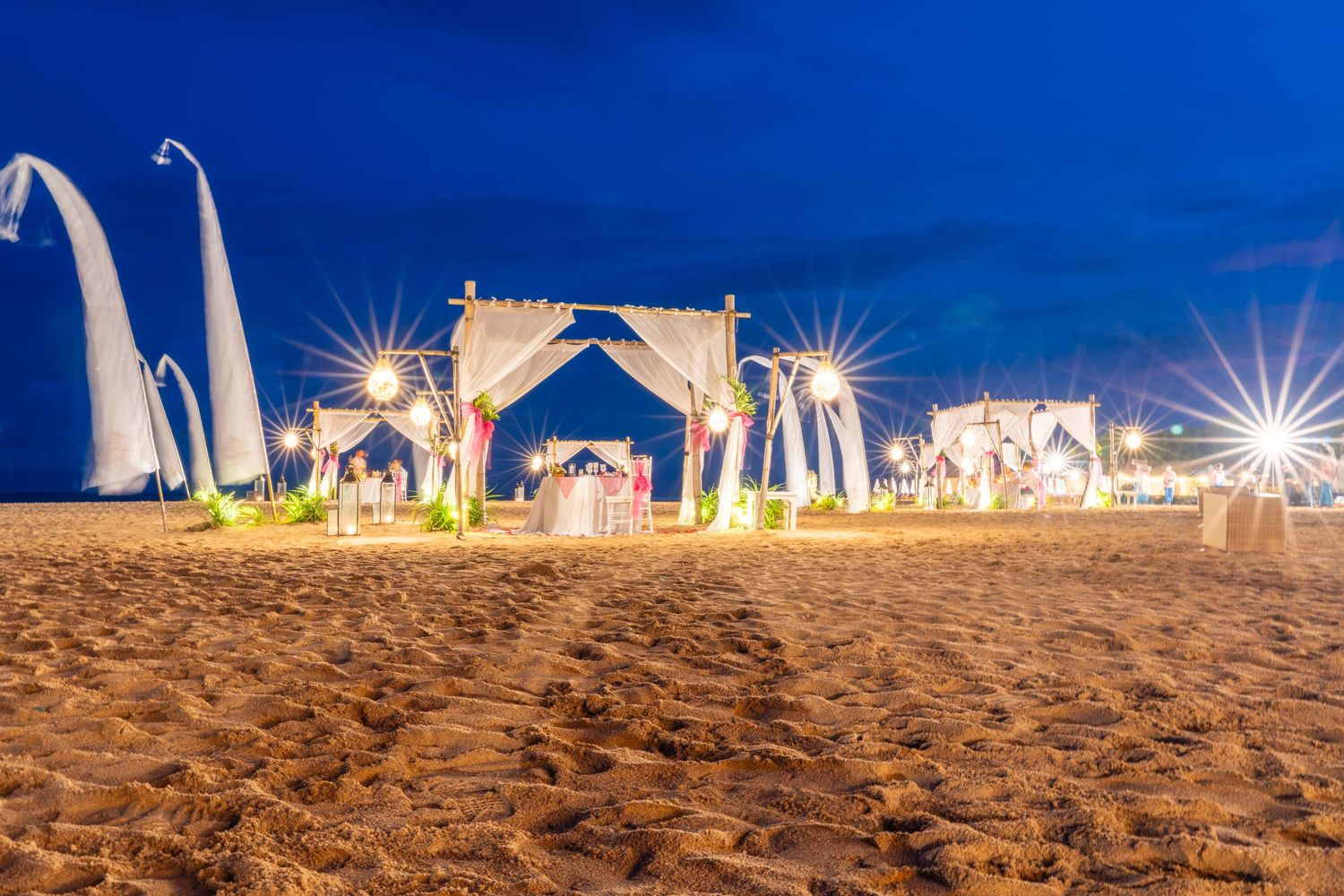 Romantic beachside dining setup at sunset.