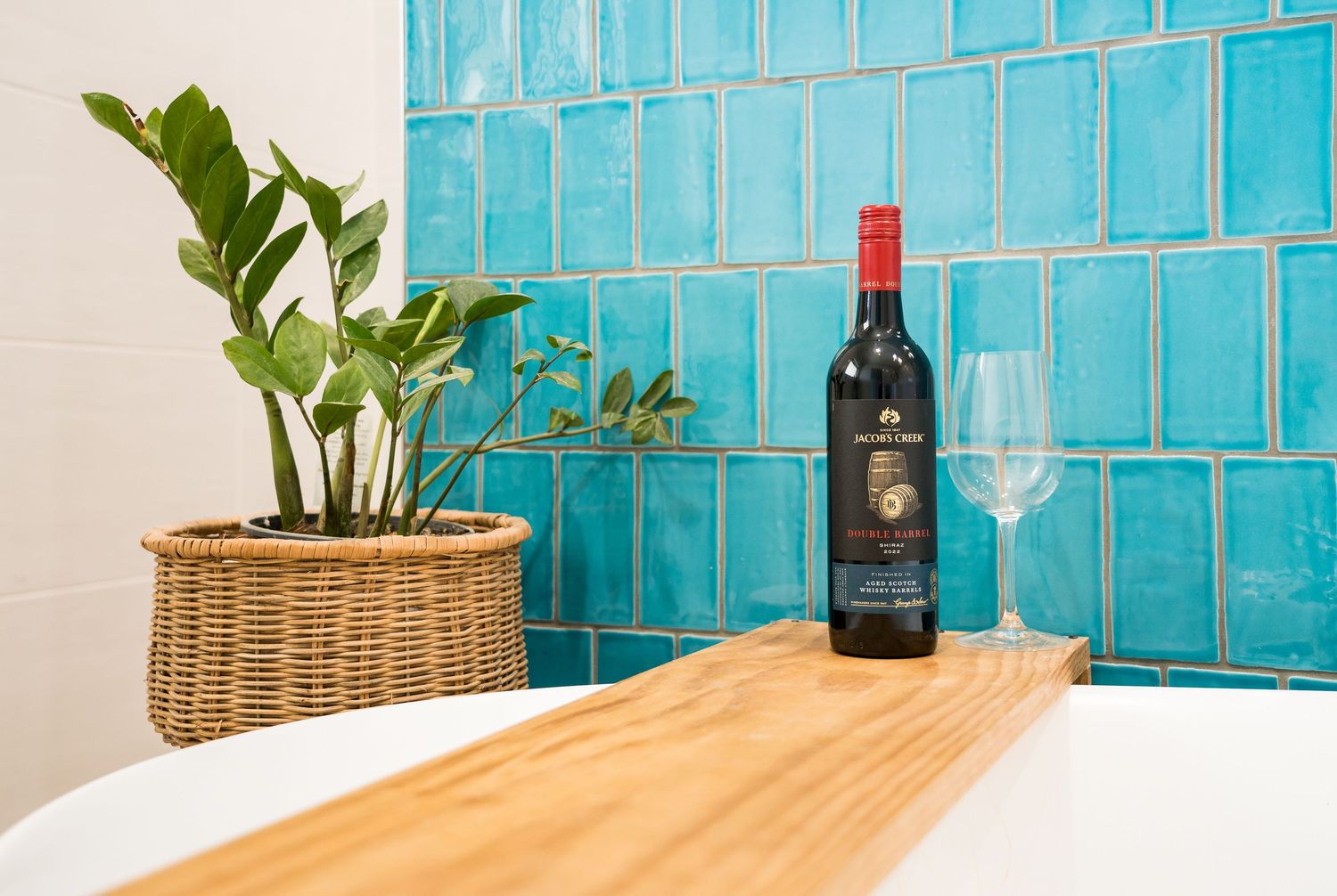 Bright modern bathroom with clean tiles and natural light. Detailed Wine
