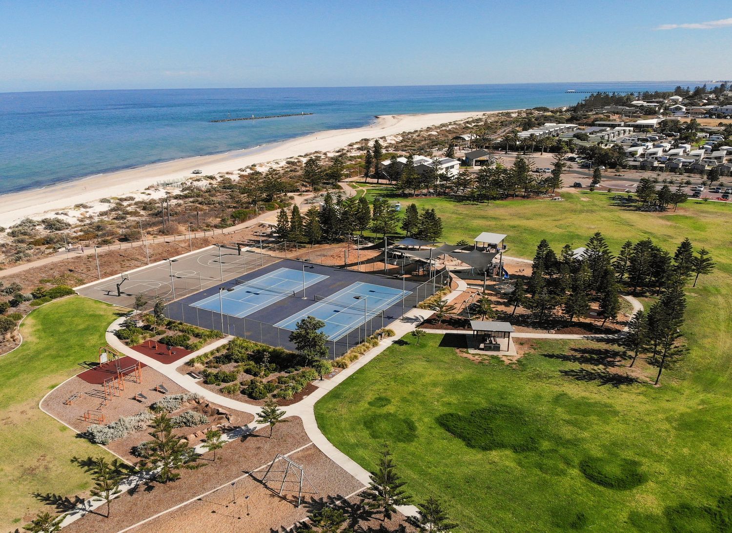 Birds‑eye drone view over parklands and natural scenery.