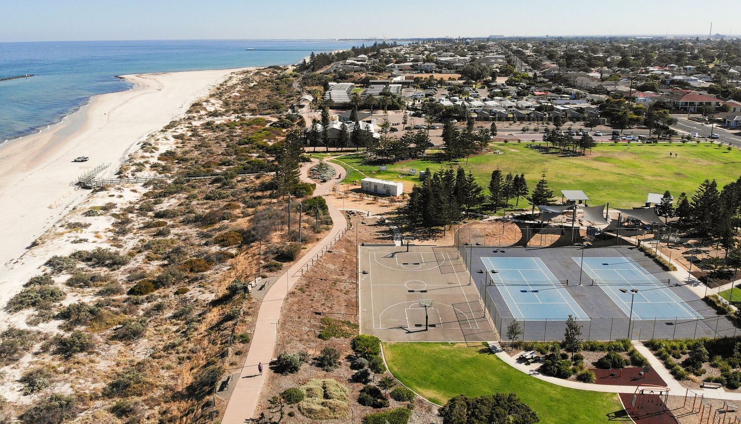 Birds‑eye drone view over parklands and natural scenery.