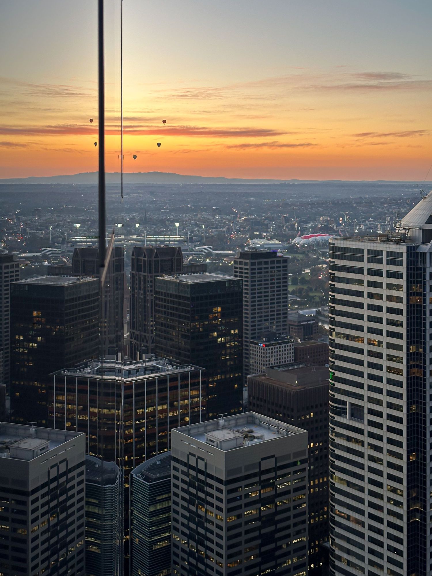 City skyline view overlooking urban buildings at sunrise.