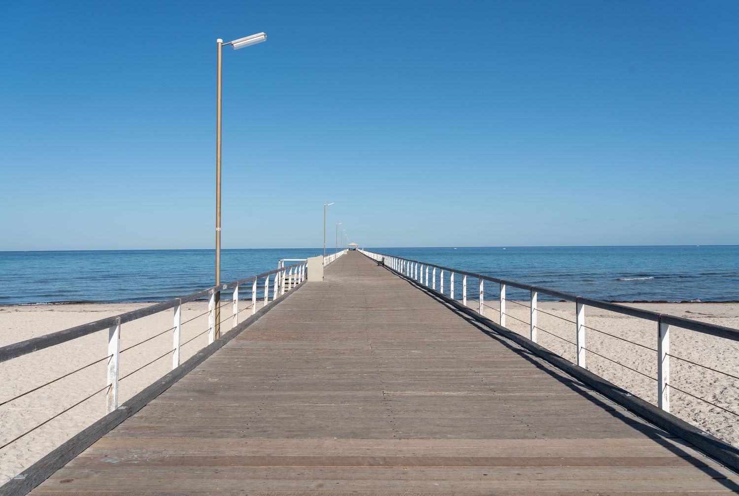 Wooden jetty extending over calm water.