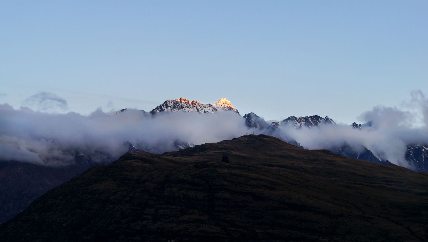 Mount Remarkables in New Zealand with dramatic peaks and cloud layers.
