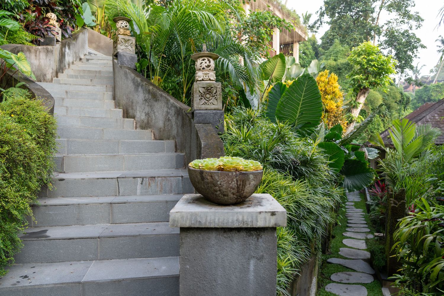 Decorative stone stairs lined with flowers and greenery.