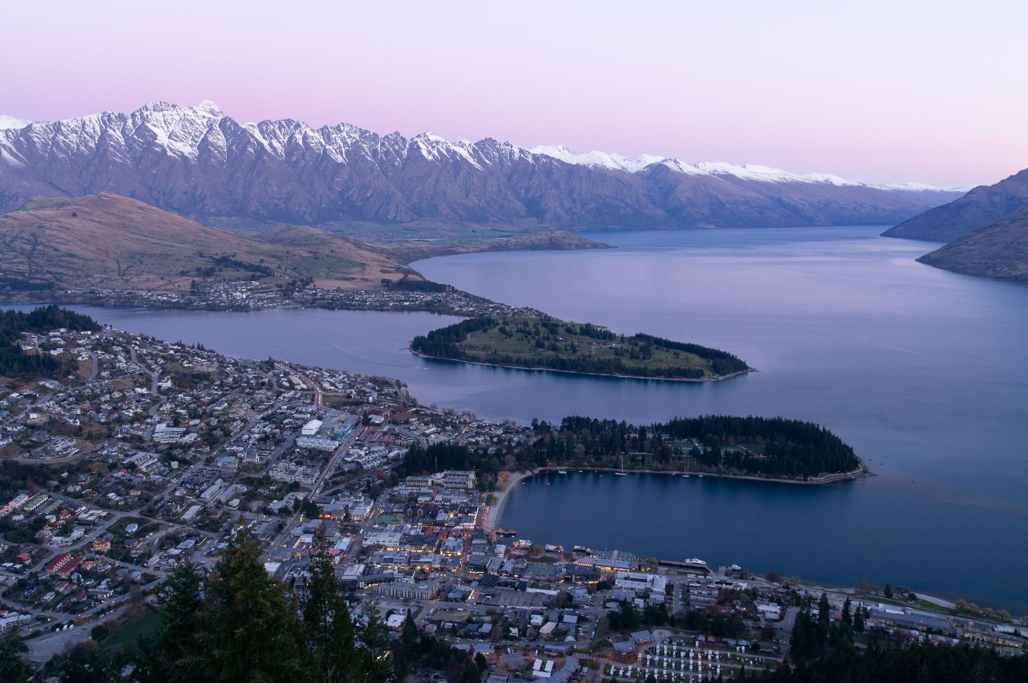 New Zealand town with the Remarkables mountain range in the background.