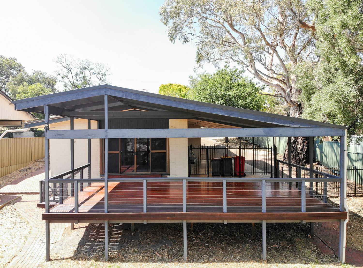 Outdoor deck area with seating and natural timber textures.