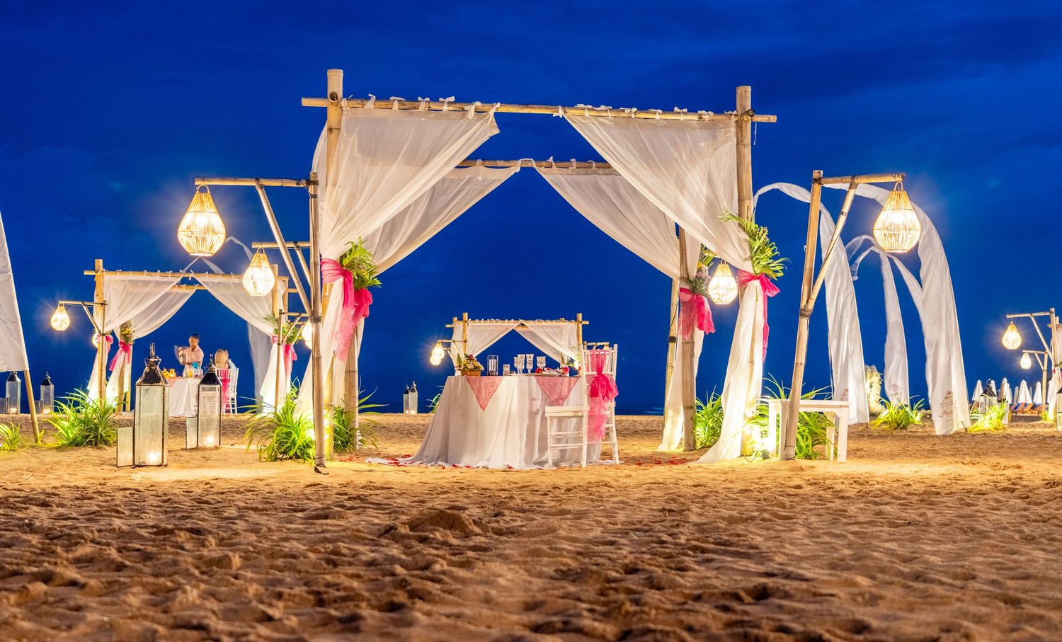 Romantic beachside dining setup at sunset.