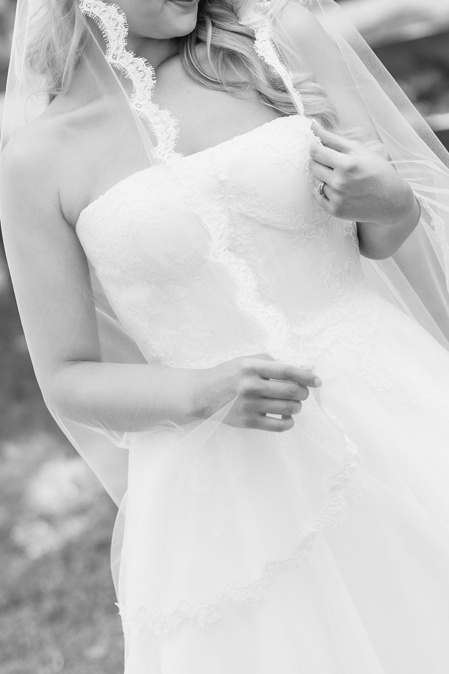 Black and white photo of a bride in a strapless lace wedding gown with veil, showcasing elegant bridal fashion, wedding at Bella Cosa