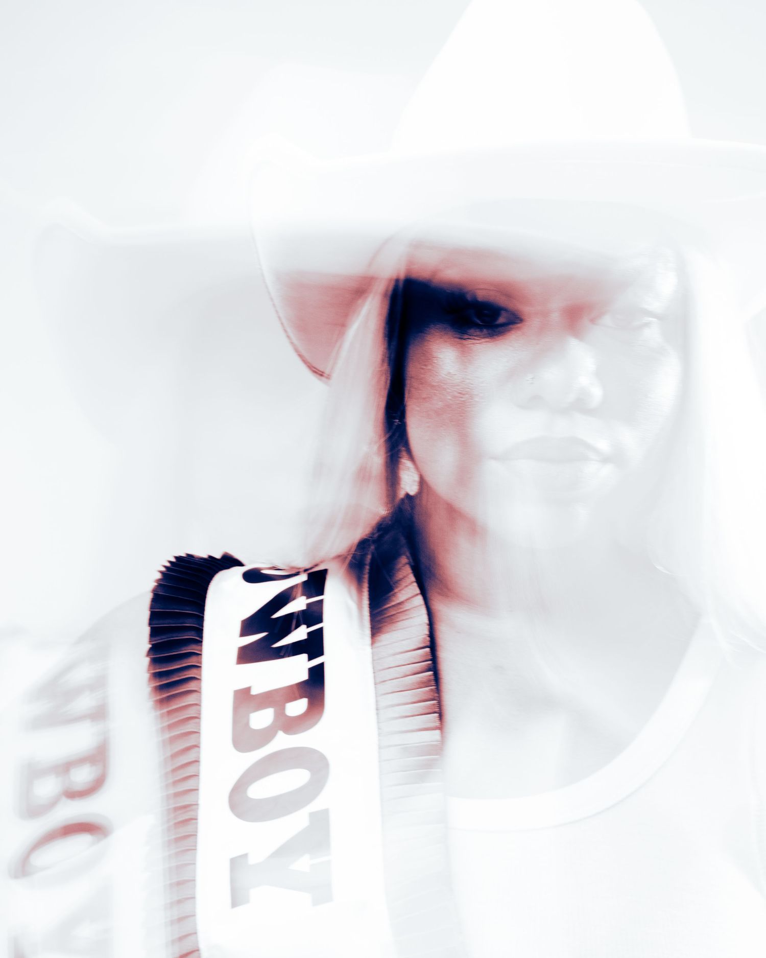 A high-contrast artistic double exposure portrait of a person wearing a cowboy hat with COWBOY text visible.
