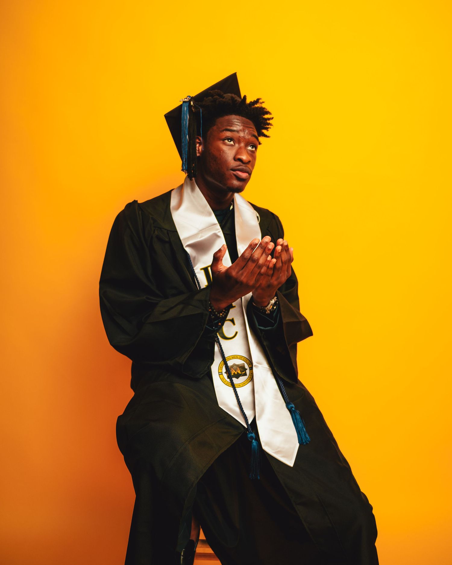 Artistic portrait series against vibrant orange background showing dynamic poses in formal attire.