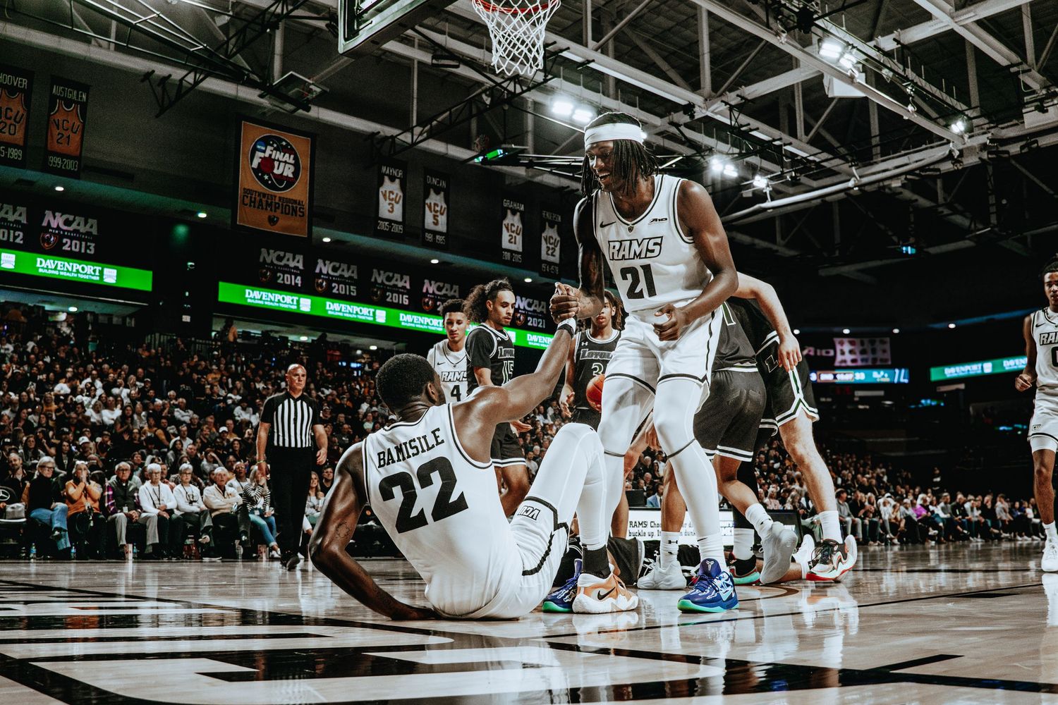Basketball players compete on a professional court during an intense game.