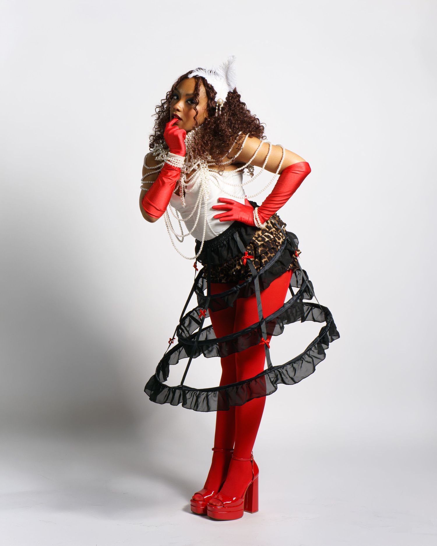 Fashion photo series featuring red and black ruffled dress with matching gloves.