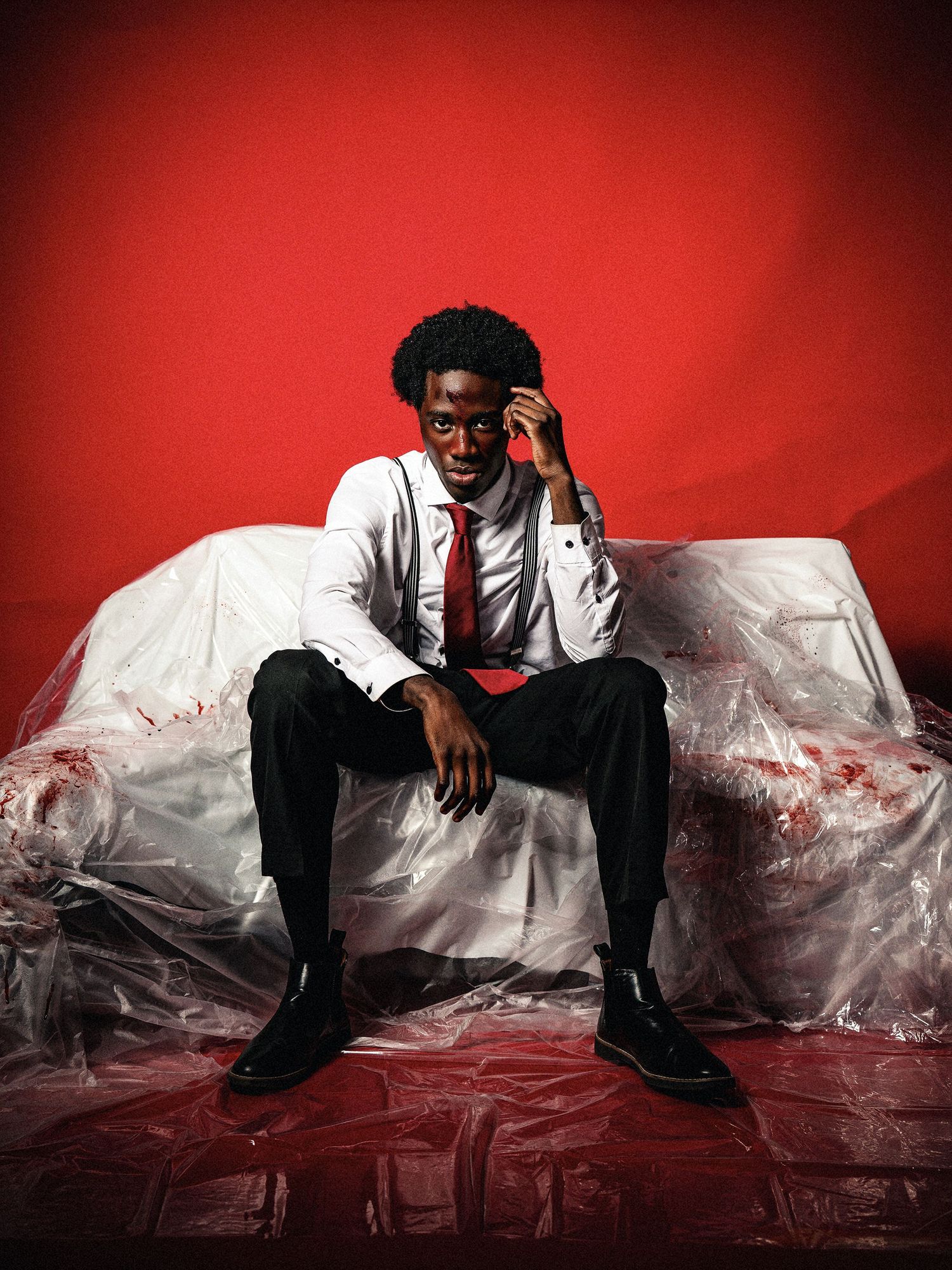 Dramatic photo sequence on red backdrop with plastic sheet and formal business attire.