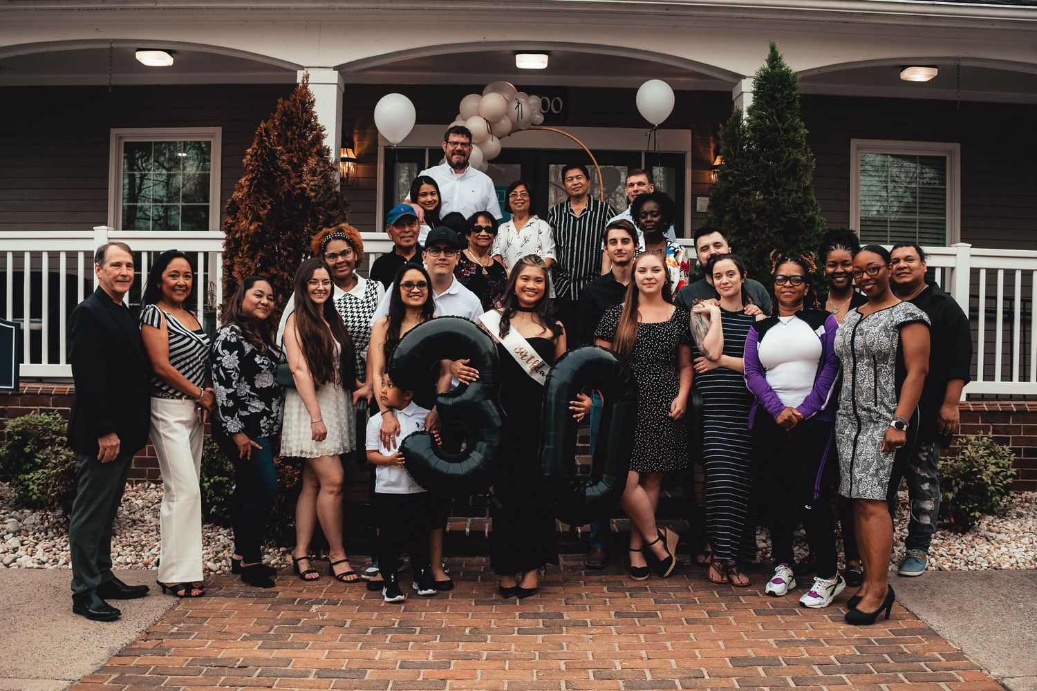 Large group of people gathered outdoors for a casual social event.