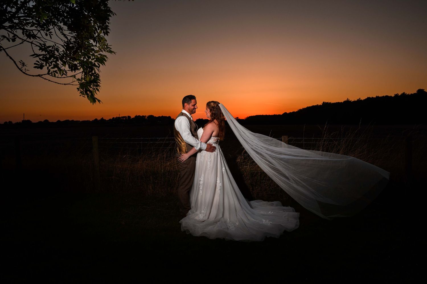 Sunset wedding photo with floating veil and dress at Horton Grange in Newcastle Northumberland
