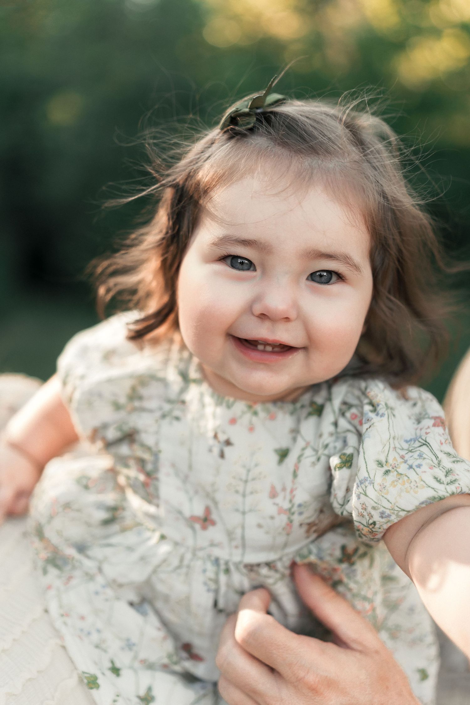 Close-up portrait of a smiling toddler during a summer family photography session.