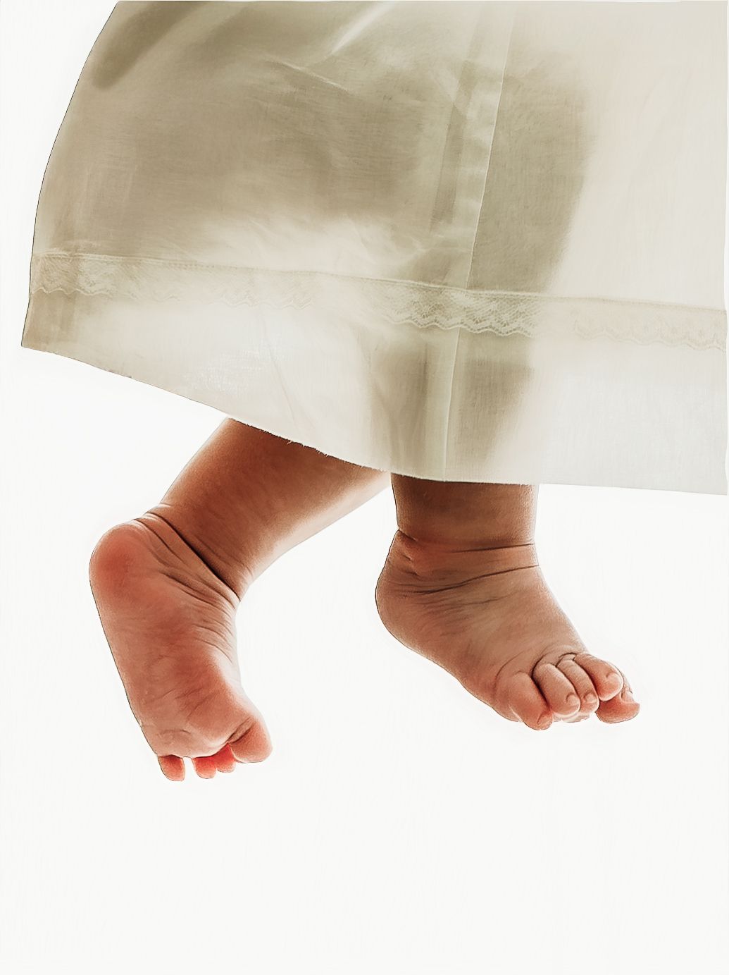 Close-up of a baby girl’s feet during a soft, neutral milestone photo session.