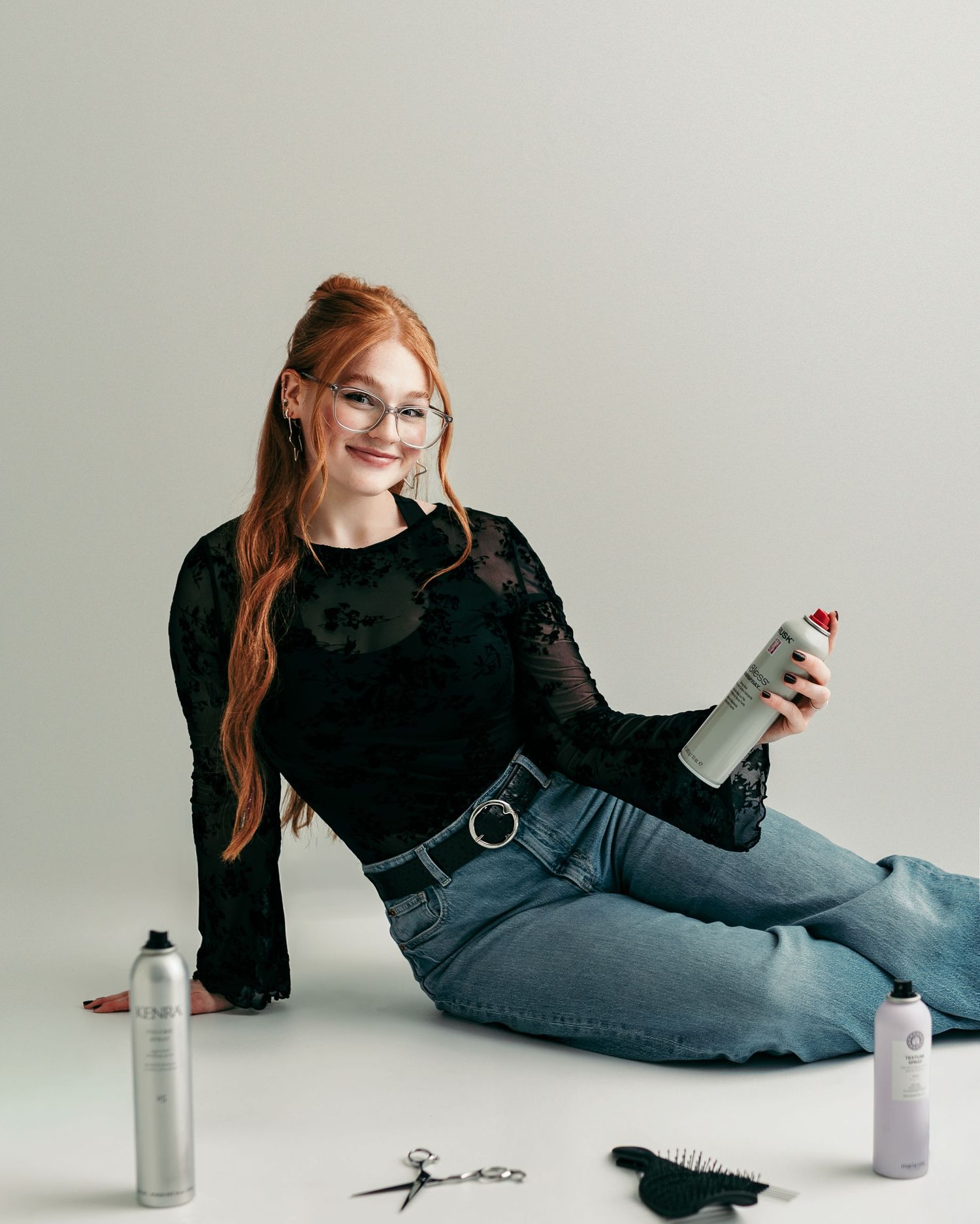 Kansas City bridal hairstylist with styling tools during a personal branding photography session.
