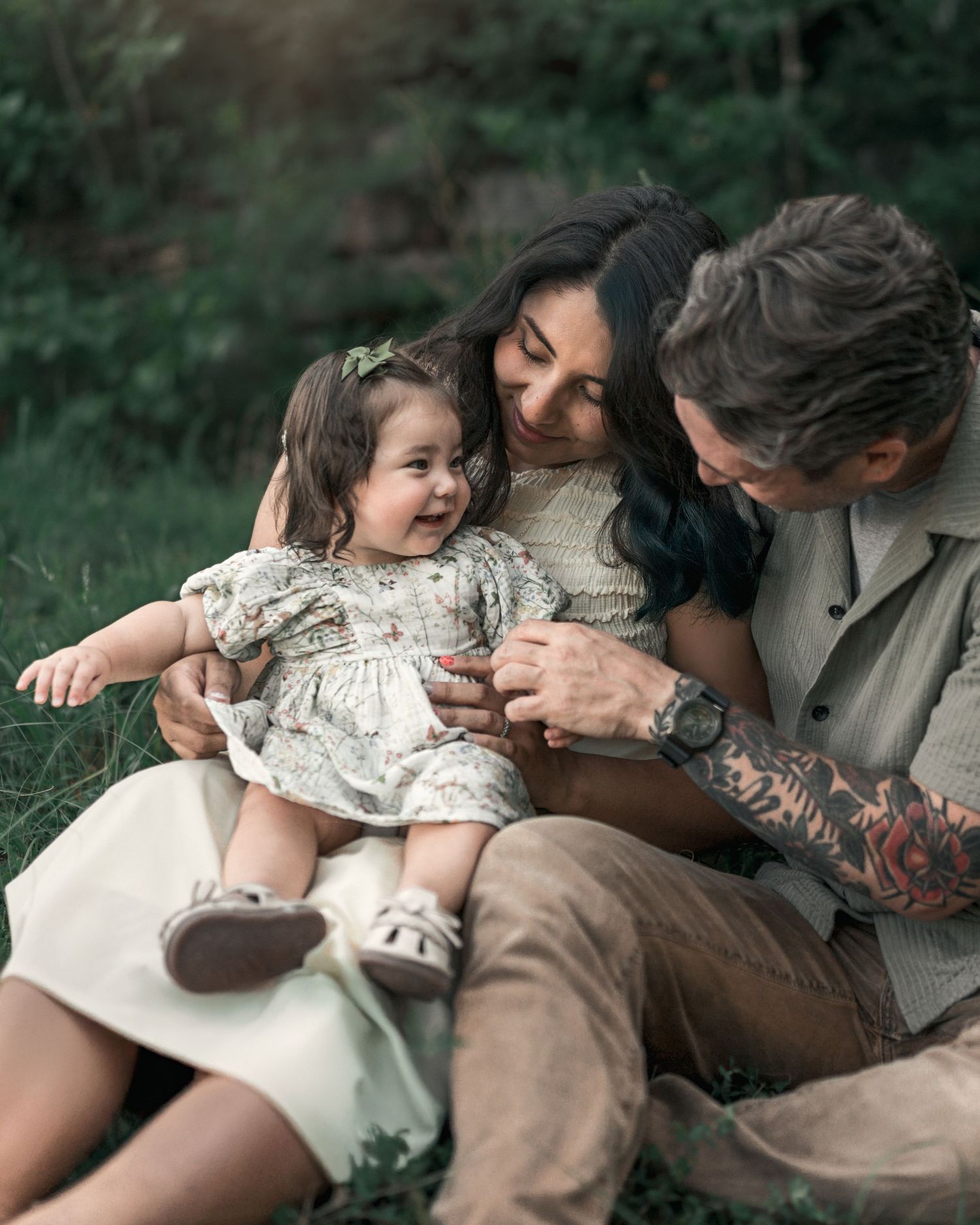 Parents playing with their daughter while enjoying a quiet evening outdoors.