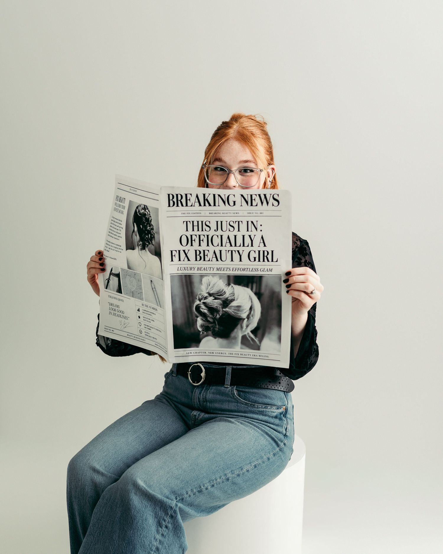 Kansas City bridal hairstylist reading a custom newspaper during a personal branding photography session.