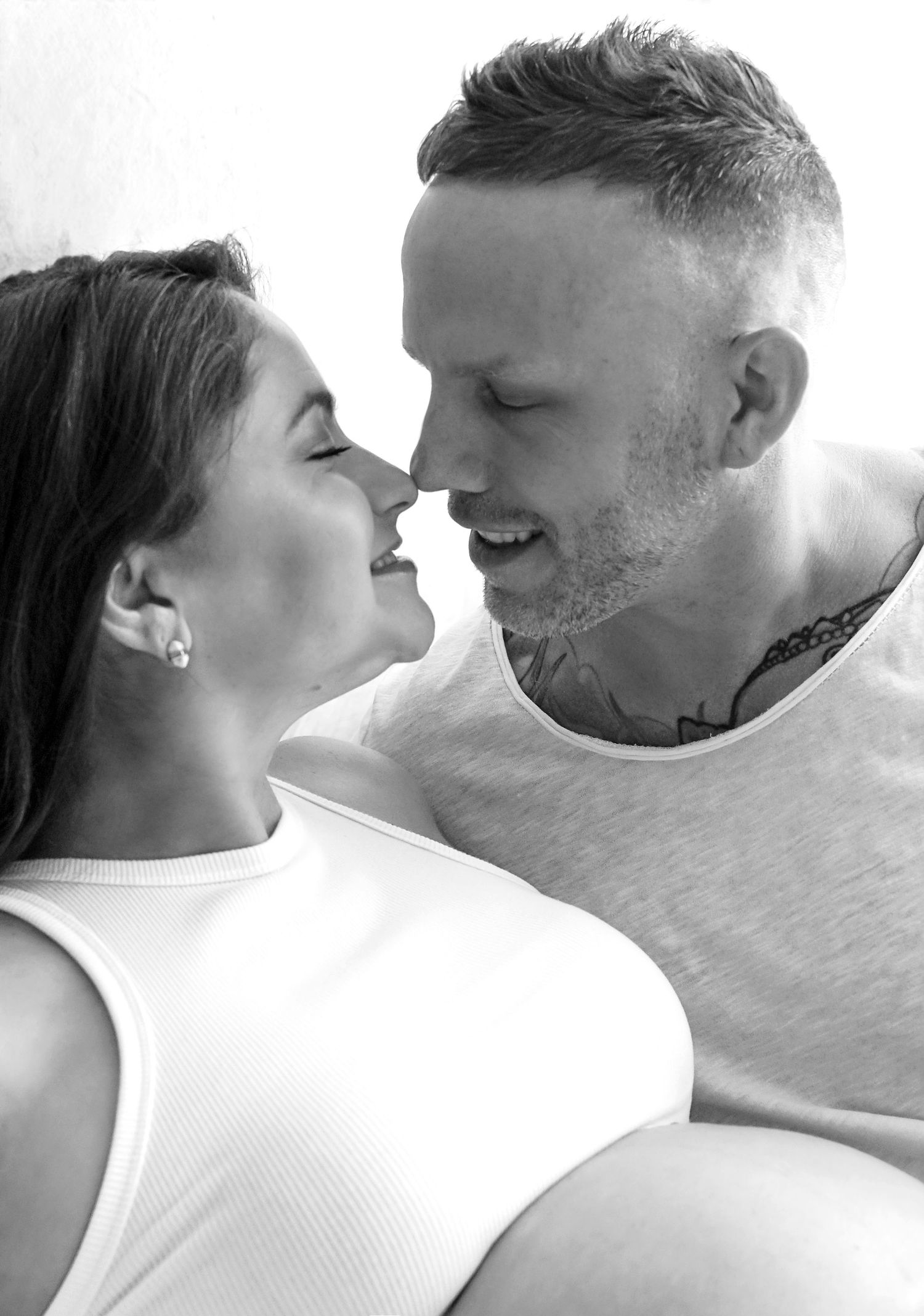 Expecting couple sharing moment during black and white maternity session Kansas City