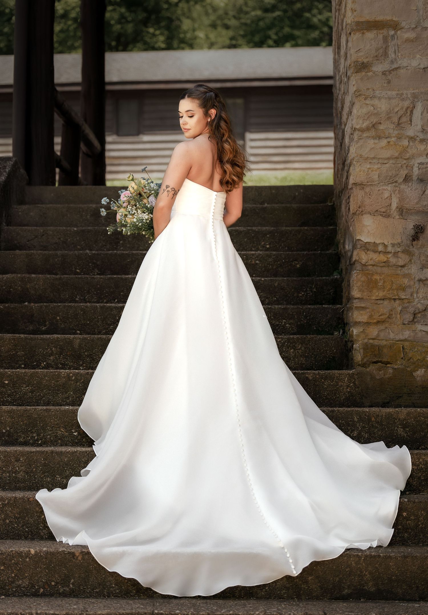 Bride portrait on stone staircase during intimate wedding at Roaring River State Park in Missouri