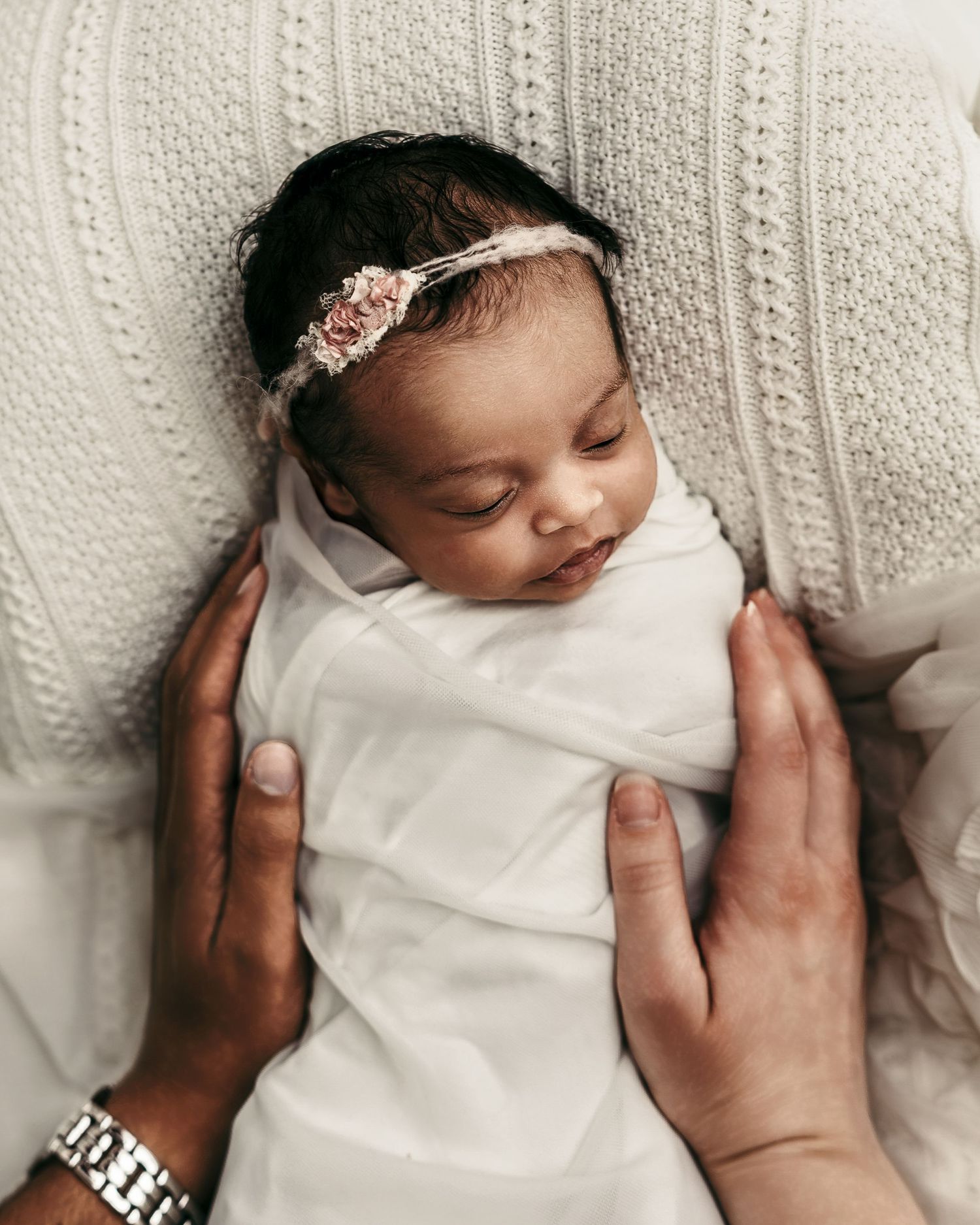 Sleeping newborn baby girl in a cream dress during a studio newborn photography session in Blue Springs near Kansas City.