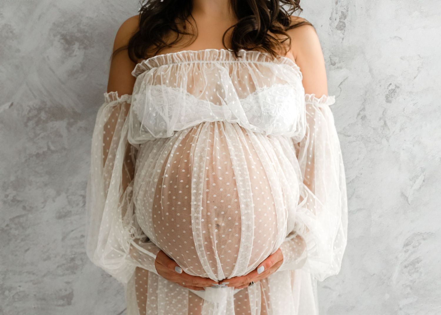 Close-up maternity portrait of pregnant belly in soft fabric Kansas City maternity photographer
