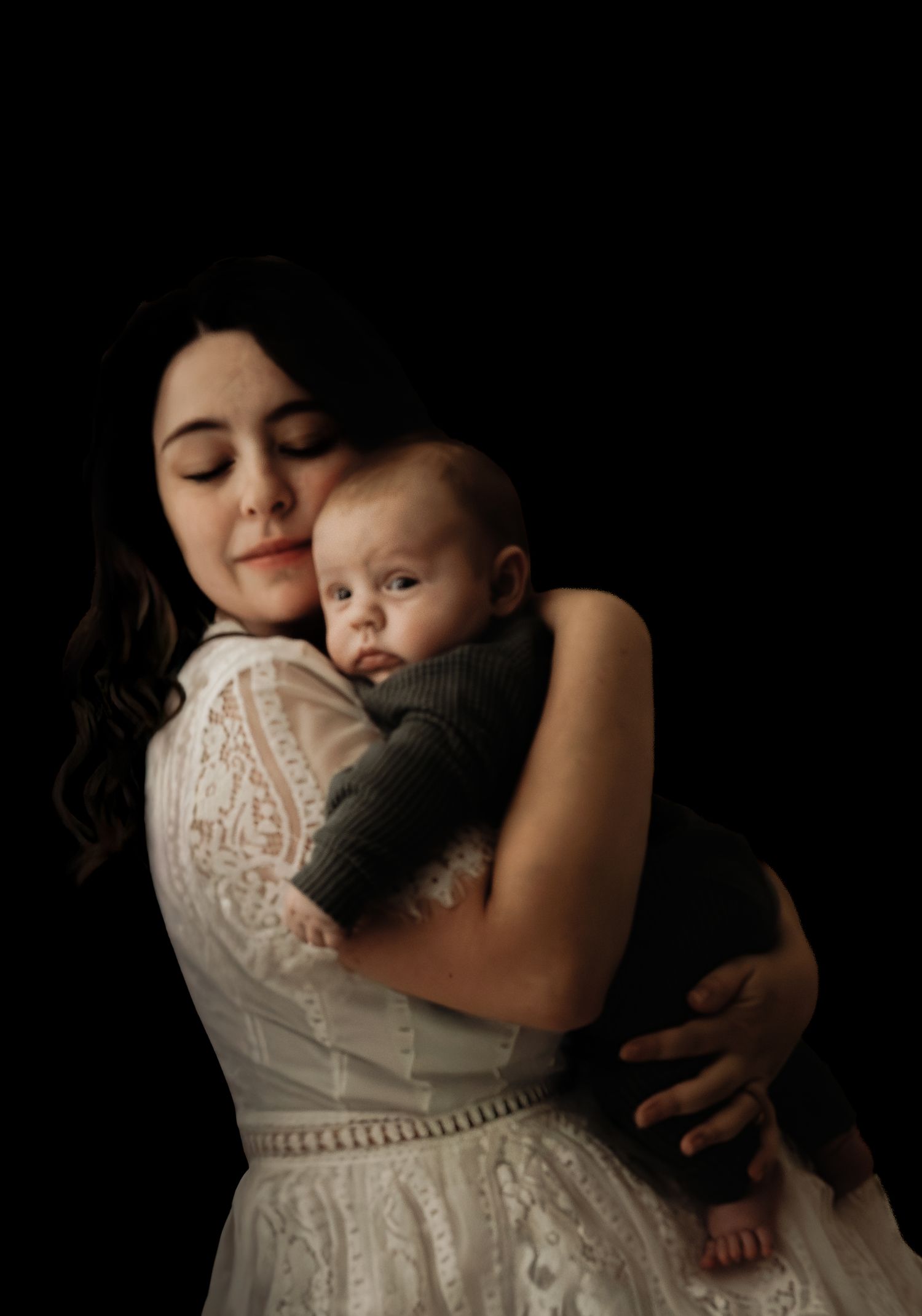Mother holding baby in soft, emotional portrait during studio motherhood session Kansas City