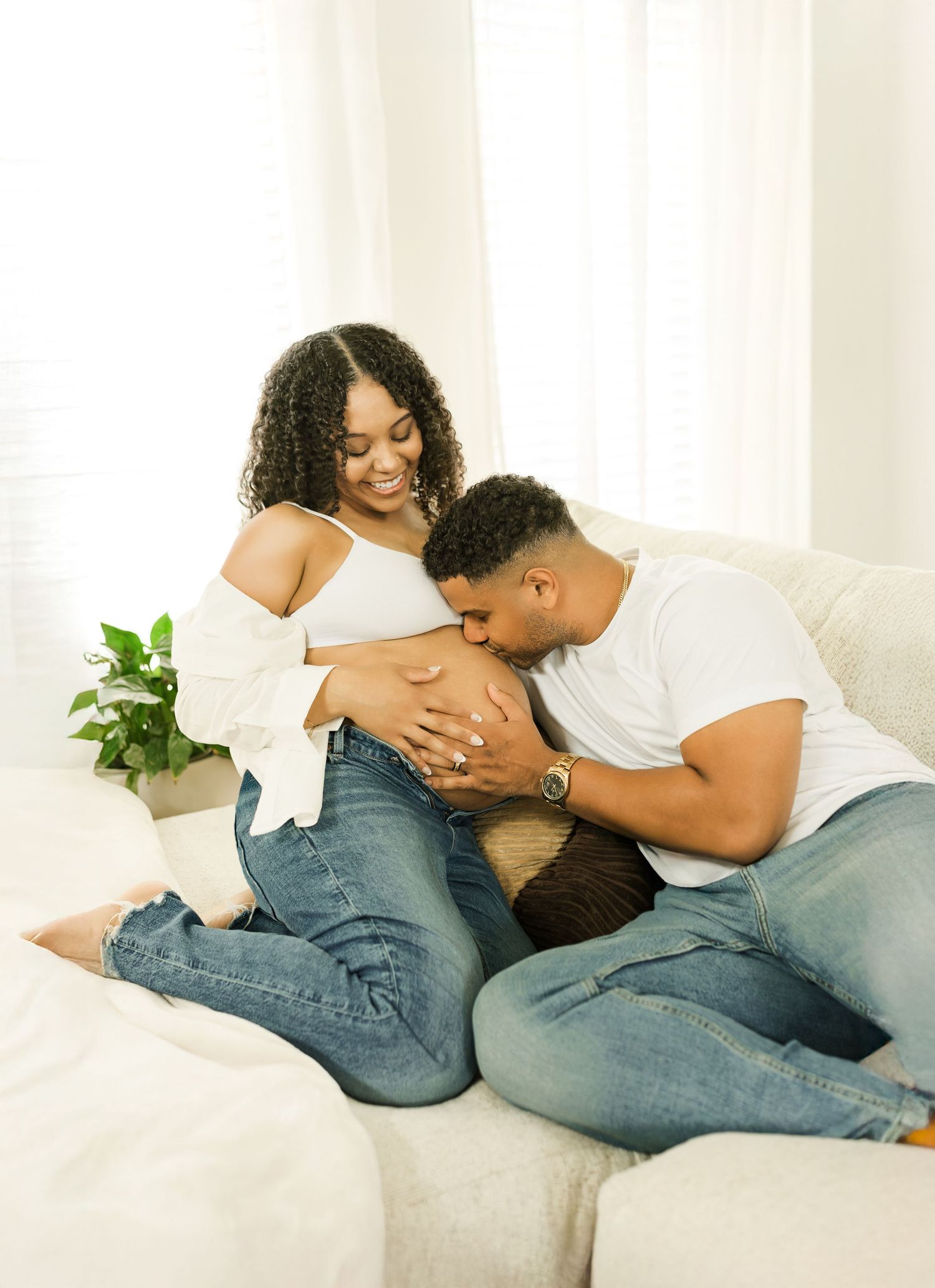 Expectant parents sharing a quiet moment during an in-home maternity session.