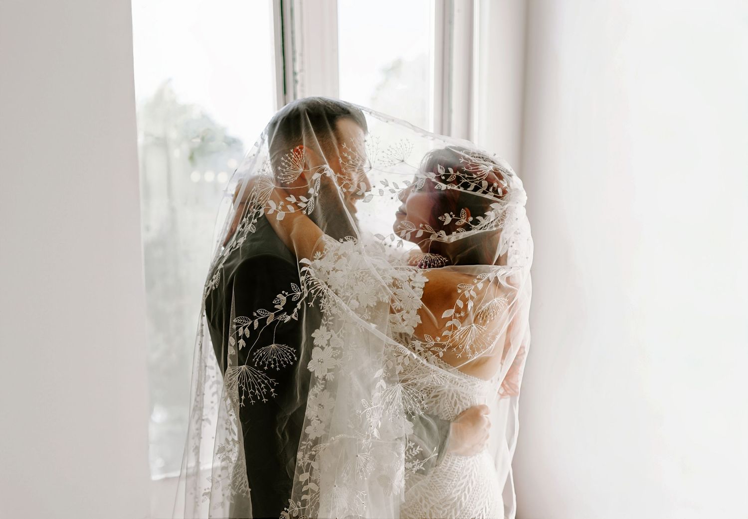 Intimate wedding photography in Kansas City, bride and groom under veil with natural light