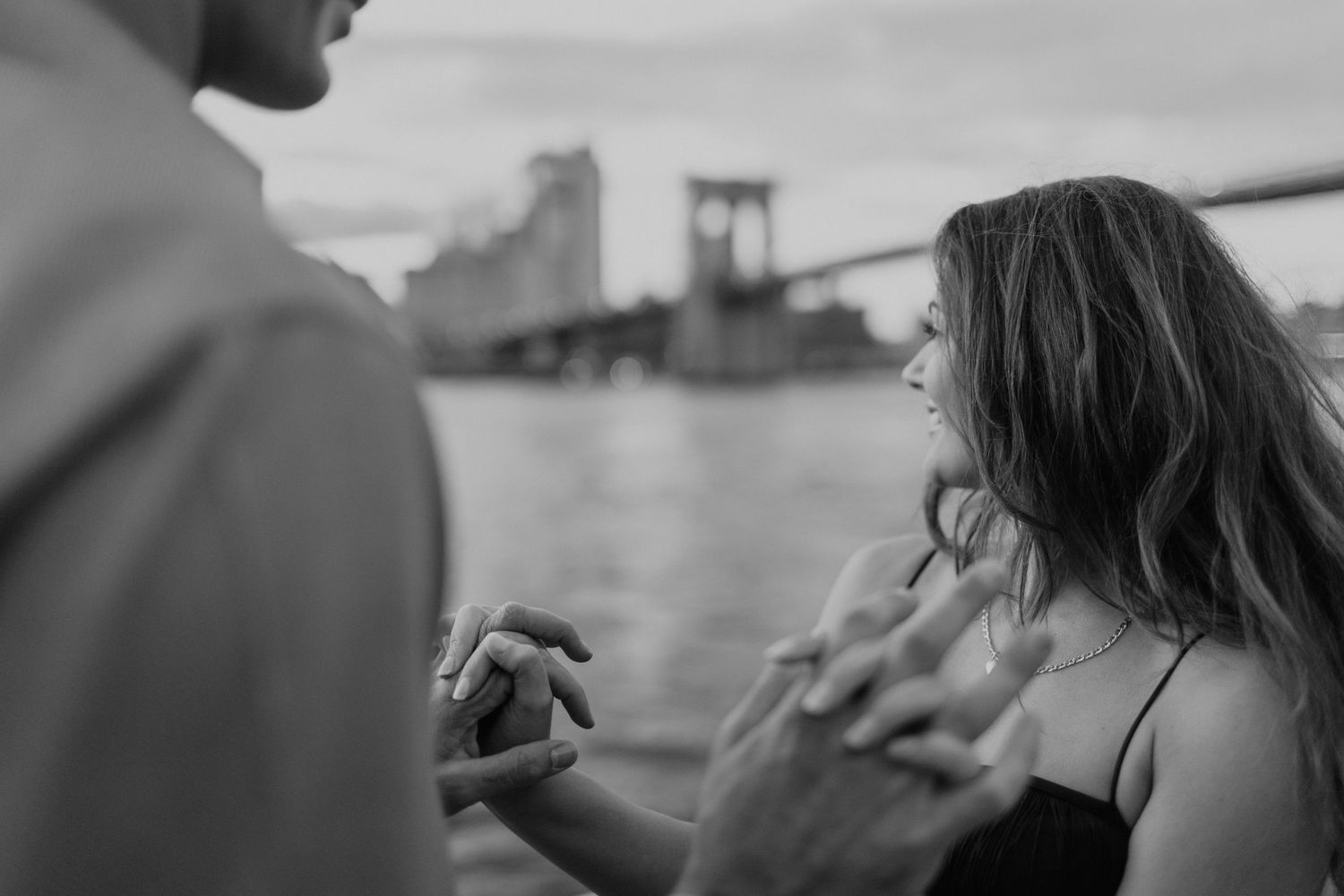 Intimate candid moments captured during an outdoor engagement session in New York City.